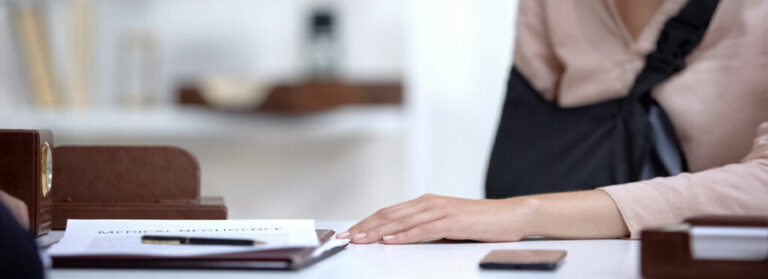 Woman With Arm Cast Looking At Document