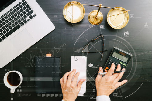 Atlanta distracted driving accident lawyer using laptop and calculator when documenting damages