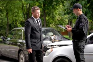 Police officer talks to driver in auto accident in North Carolina