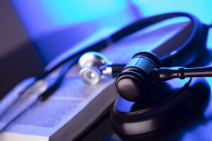 Burn Injury Lawyer Charlotte, NC with a gavel and stethoscope with a blue tint
