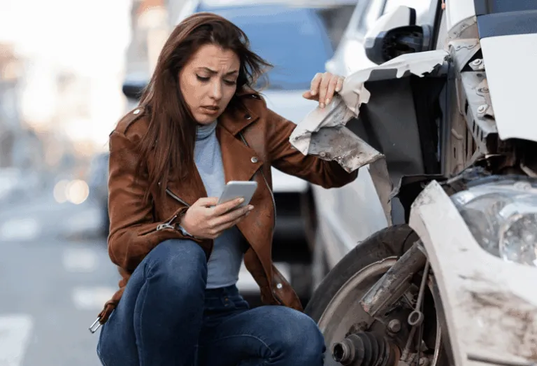 Woman On Phone After Car Crash