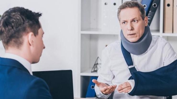 An injured man meeting with an Alpharetta workers' compensation lawyer