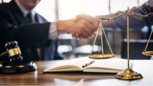 Atlanta reckless driving accident lawyer shaking hands with insurance adjuster in settlement agreement