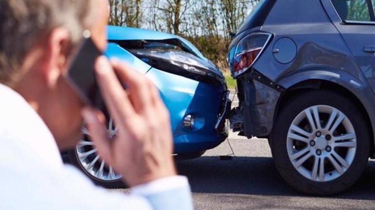 Man calling police to report car accident.