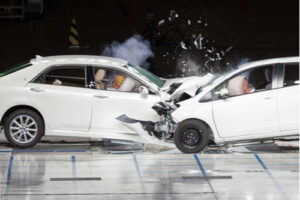Front-end collision during crash test with front of two cars torn open