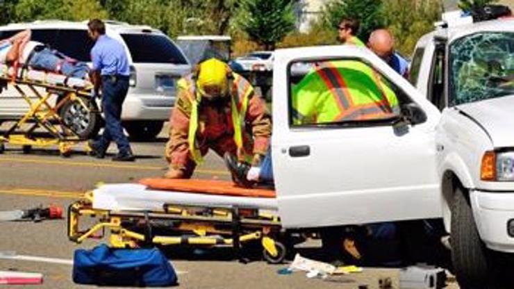 Emergency workers helping people involved in a car accident