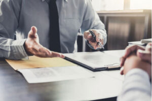 Atlanta head-on car accident lawyer in shirt and tie meeting with client