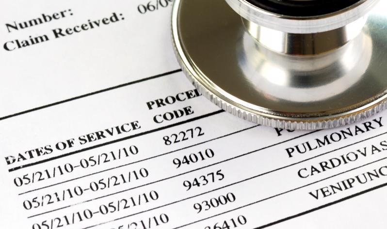 Medical bills and a stethoscope.